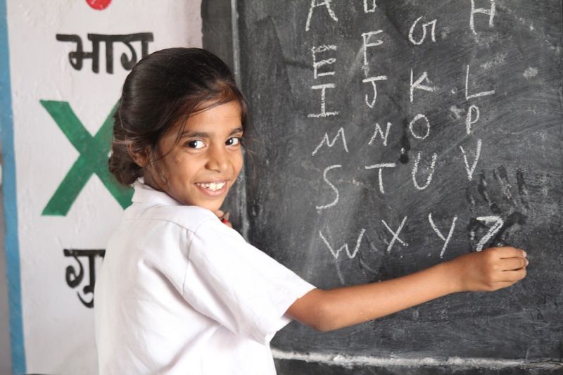 girl writing on a chalkboard